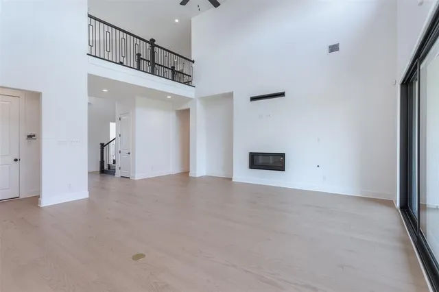 a view of a house with a yard and a large tree