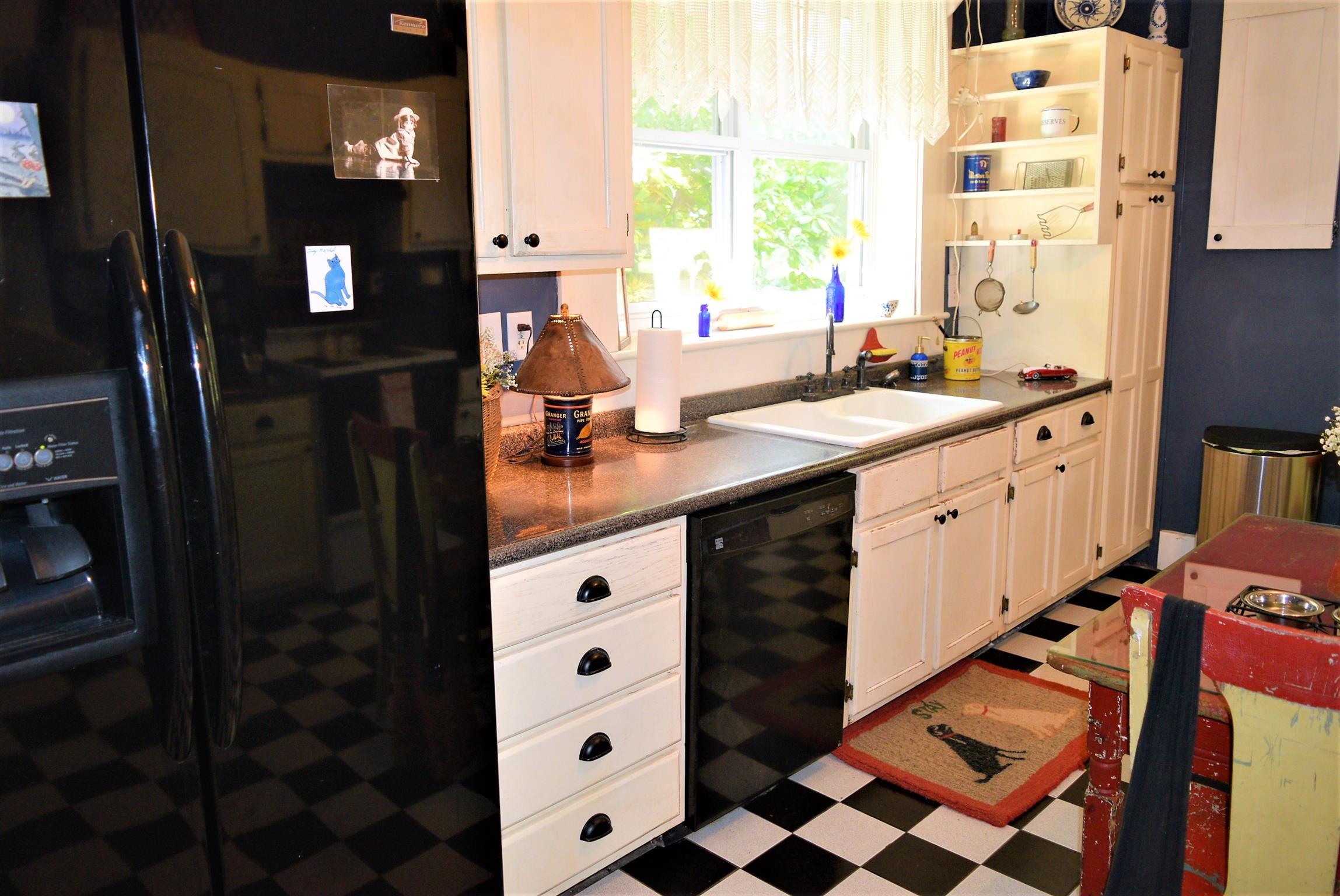 425 Spring Street Guthrie, KY 42234 - Photo 16 of 30 a kitchen with a sink window and cabinets