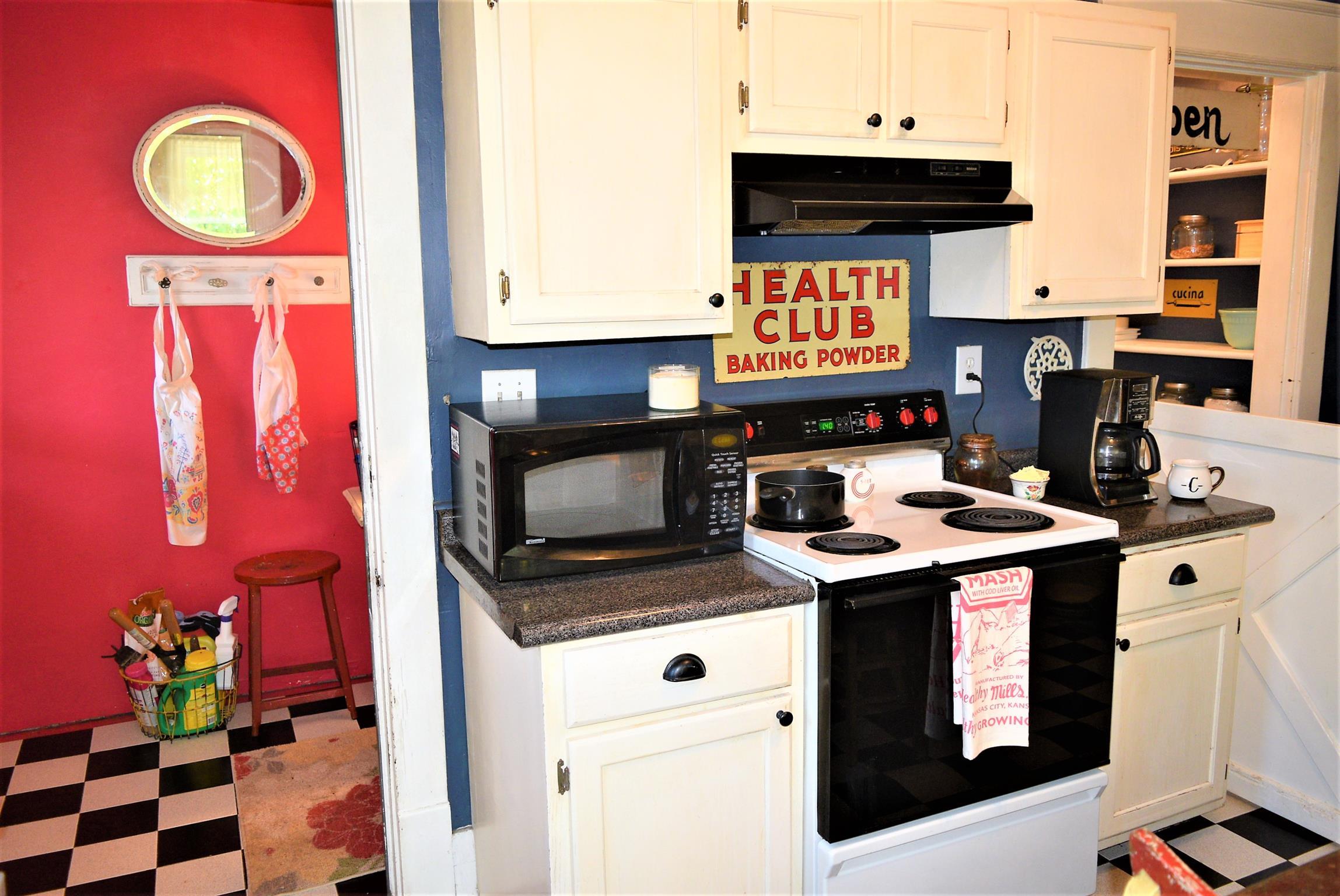 425 Spring Street Guthrie, KY 42234 - Photo 18 of 30 a kitchen with stainless steel appliances granite countertop a stove and a microwave