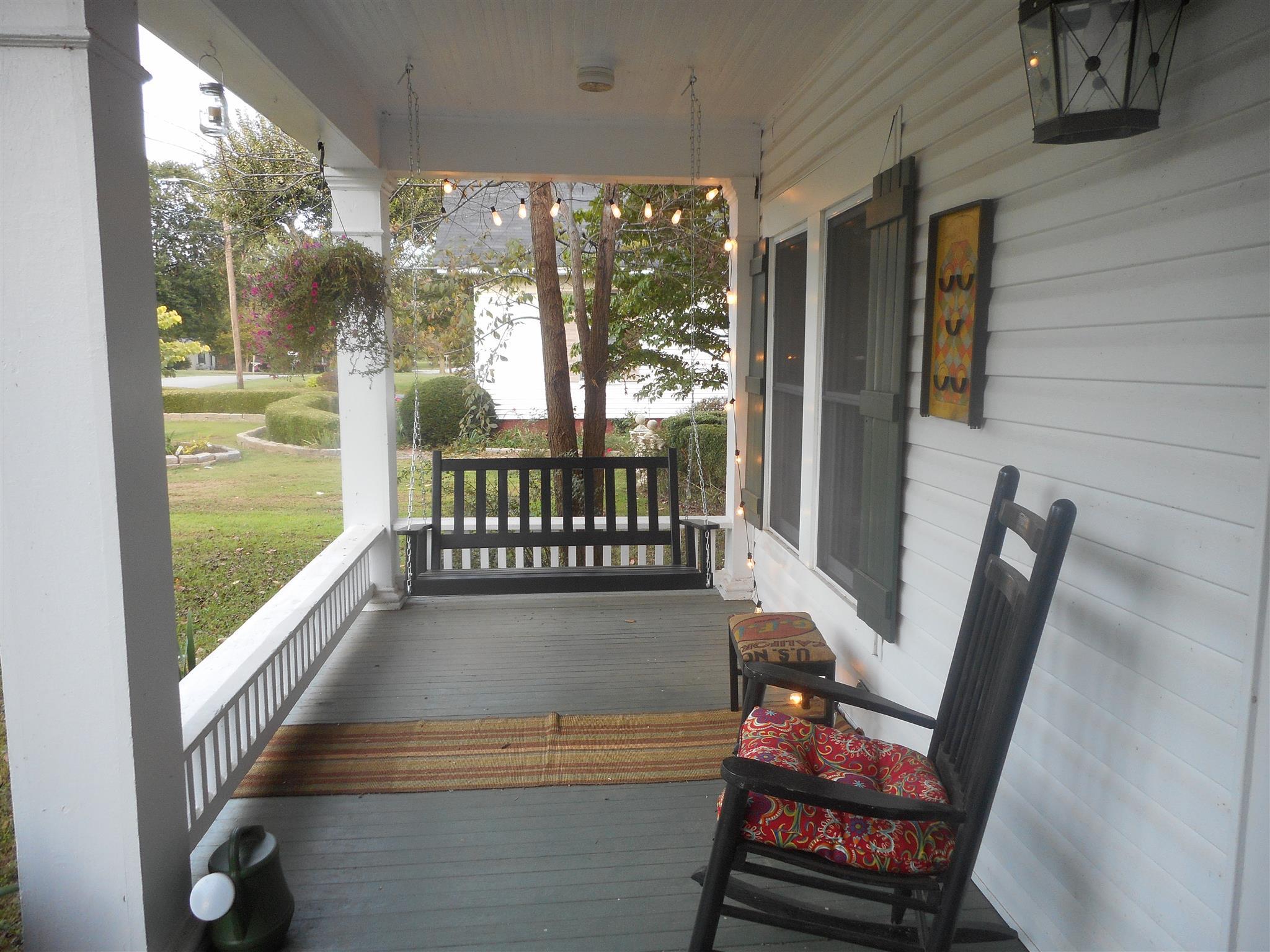 425 Spring Street Guthrie, KY 42234 - Photo 2 of 30 a bench sitting in balcony with wooden floor
