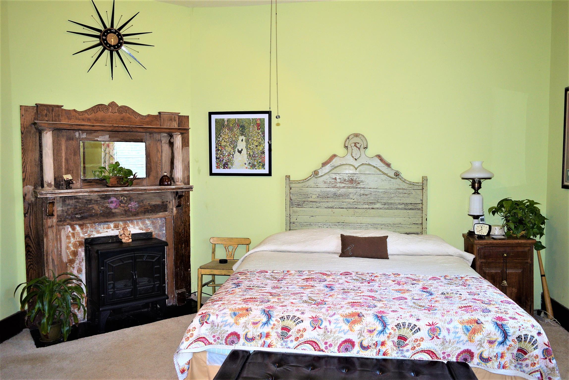 425 Spring Street Guthrie, KY 42234 - Photo 21 of 30 a bedroom with a bed and a fireplace