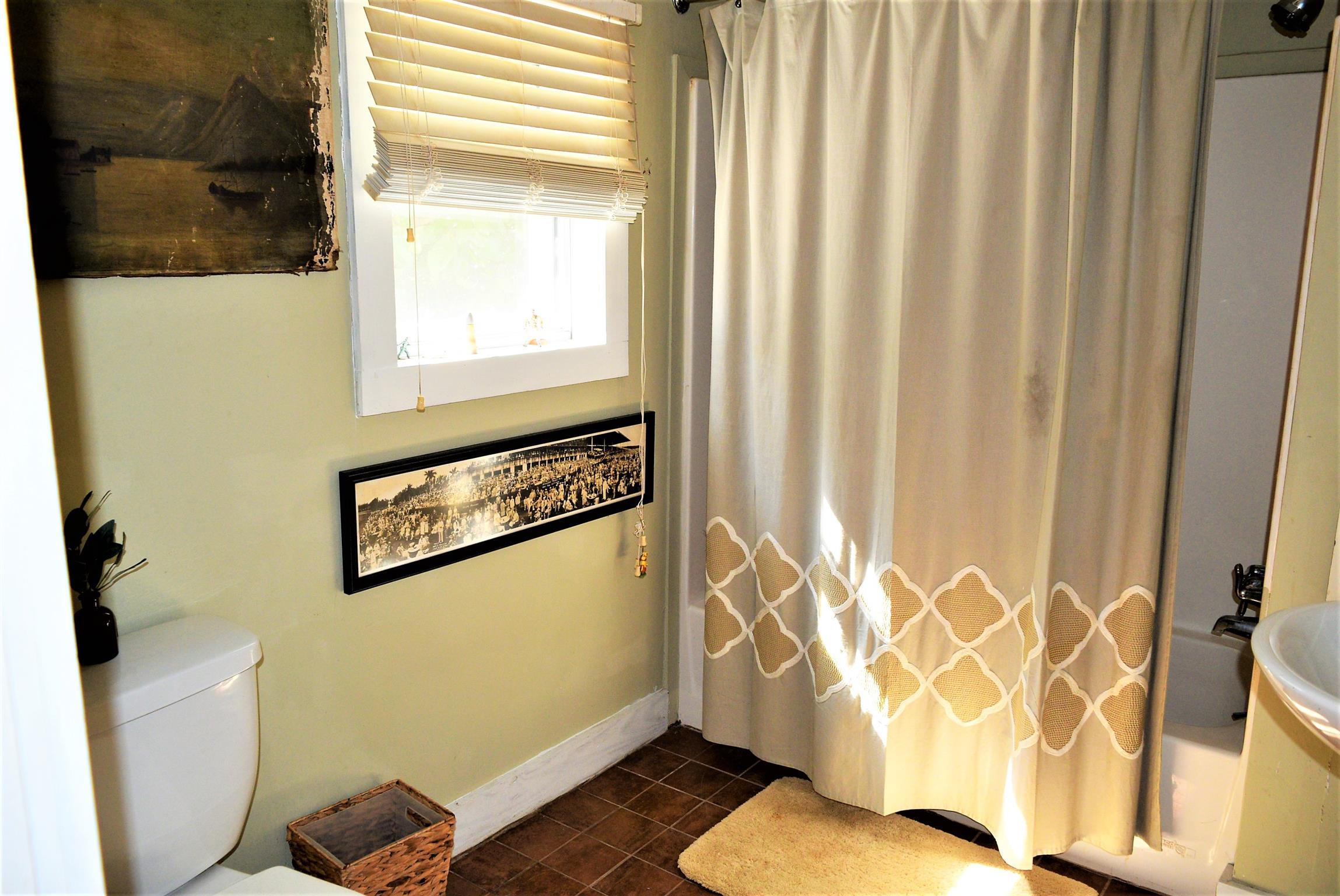 425 Spring Street Guthrie, KY 42234 - Photo 26 of 30 a bathroom with a toilet and a shower curtain