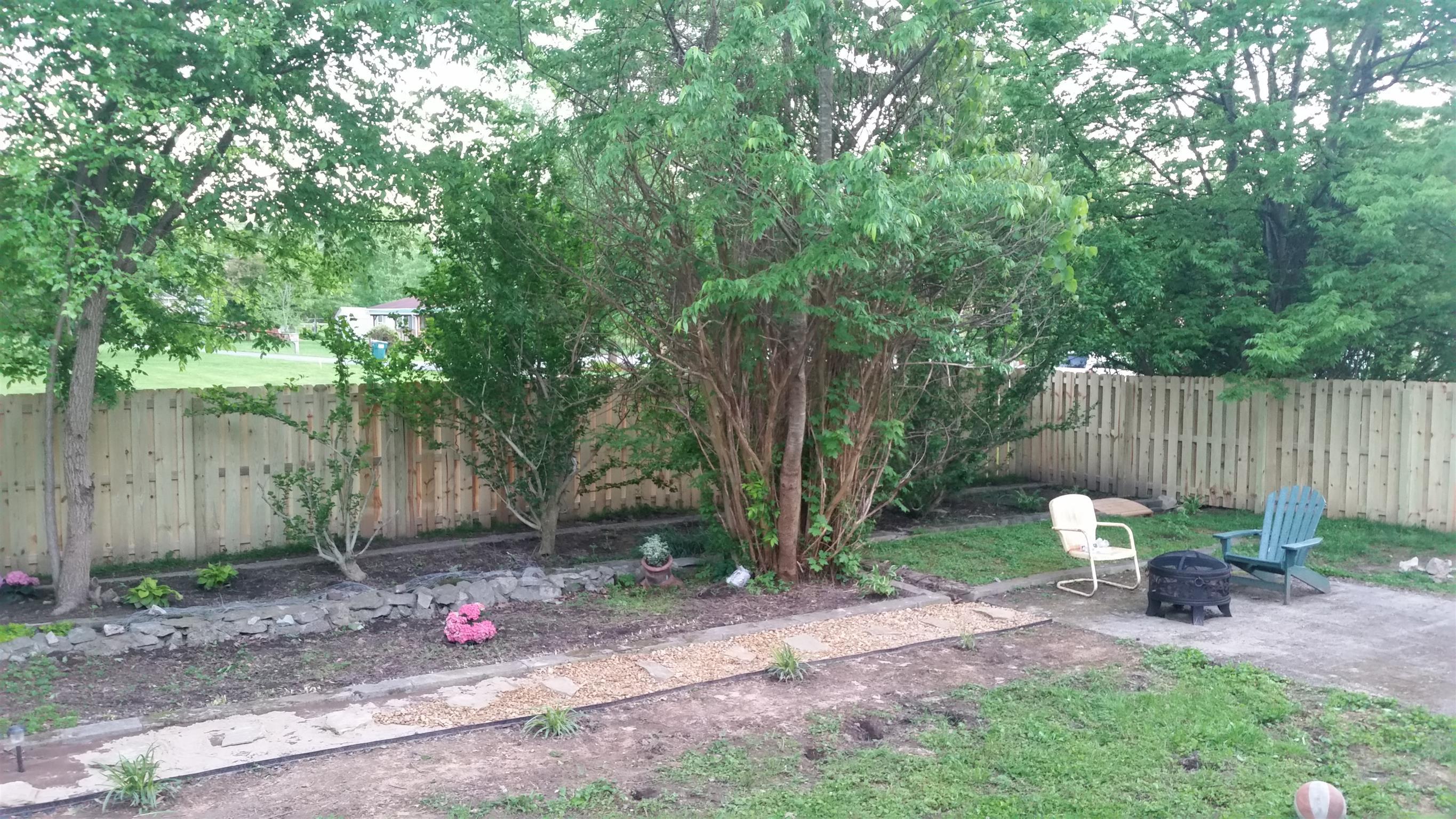 425 Spring Street Guthrie, KY 42234 - Photo 28 of 30 a view of a backyard with chairs potted plants and wooden fence