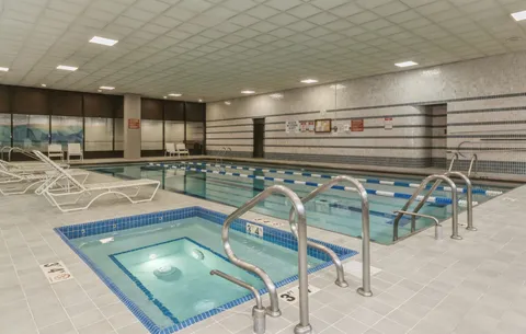 a kitchen with stainless steel appliances granite countertop a sink a stove and cabinets