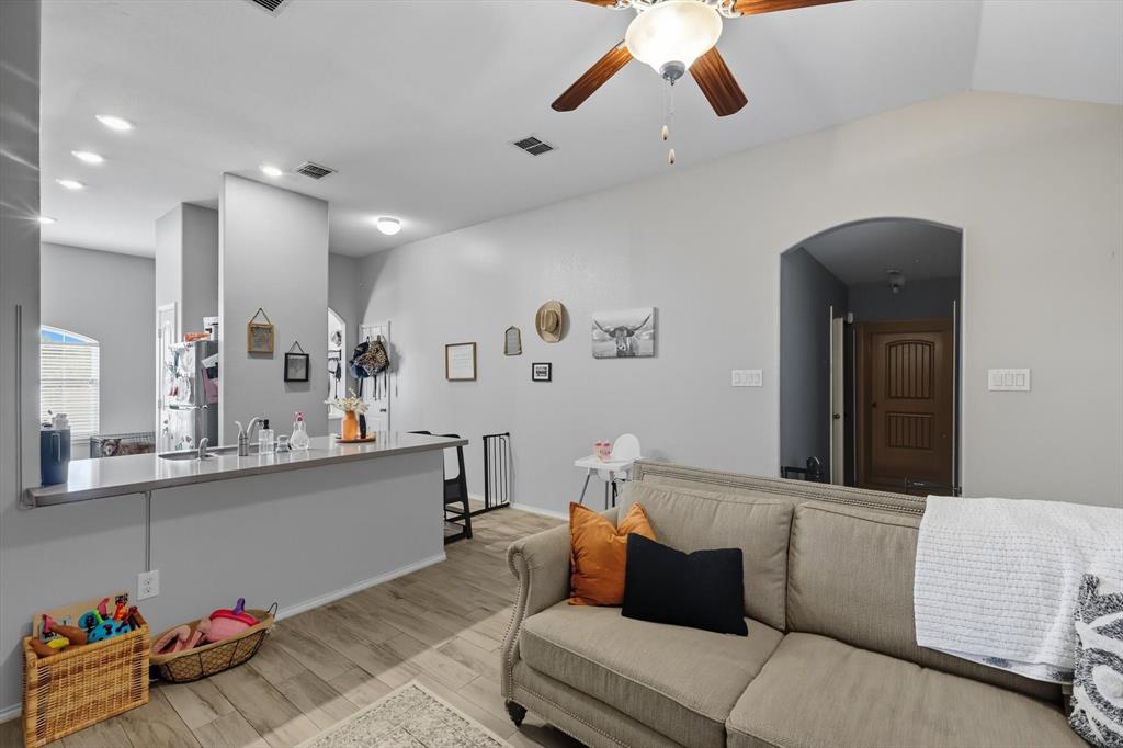14564 Serrano Ridge Road Fort Worth, TX 76052 - Photo 13 of 29 a living room with furniture and a wooden floor
