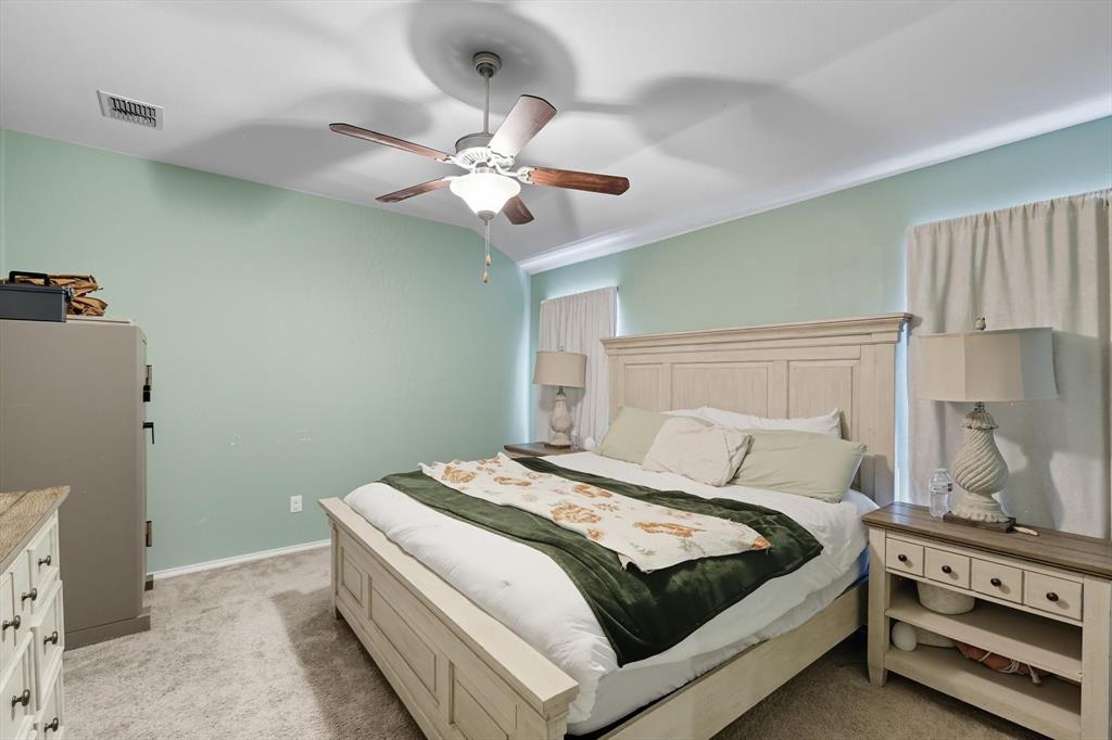 14564 Serrano Ridge Road Fort Worth, TX 76052 - Photo 14 of 29 a bedroom with a bed and a chandelier