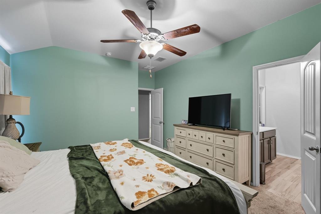 14564 Serrano Ridge Road Fort Worth, TX 76052 - Photo 15 of 29 a bedroom with a bed and a flat screen tv