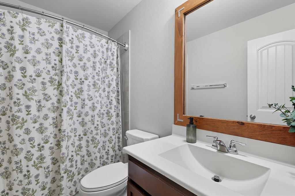 14564 Serrano Ridge Road Fort Worth, TX 76052 - Photo 19 of 29 a bathroom with a sink toilet and shower