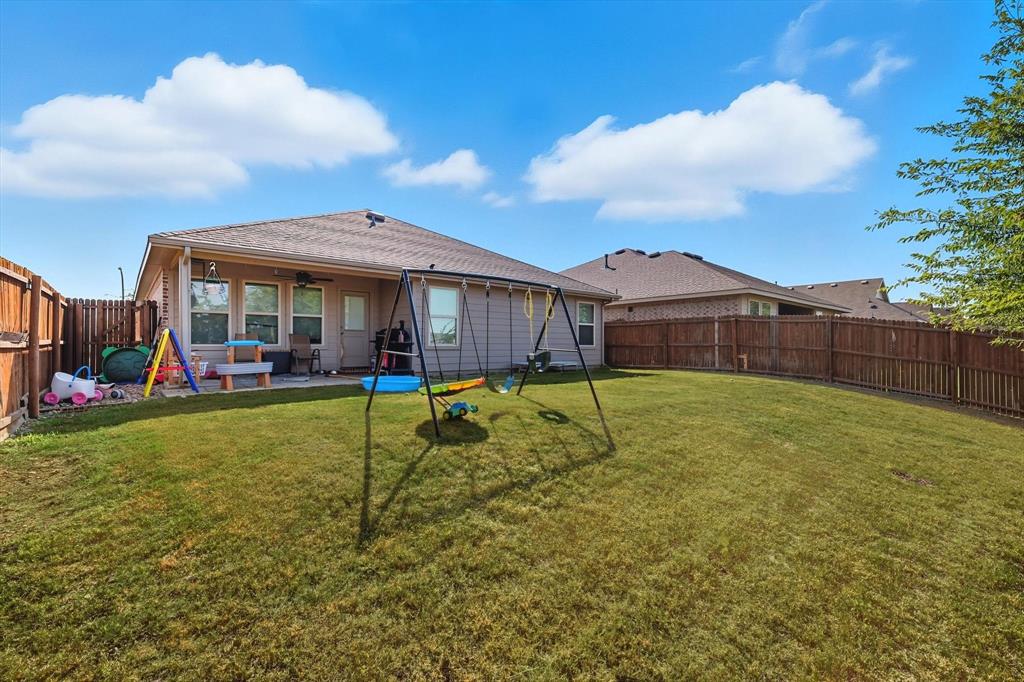 14564 Serrano Ridge Road Fort Worth, TX 76052 - Photo 22 of 29 a view of a house with a big yard and a large tree