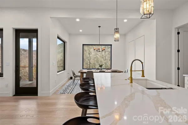 a view of a kitchen with dining table and windows