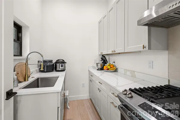 a kitchen with a sink and a stove top oven