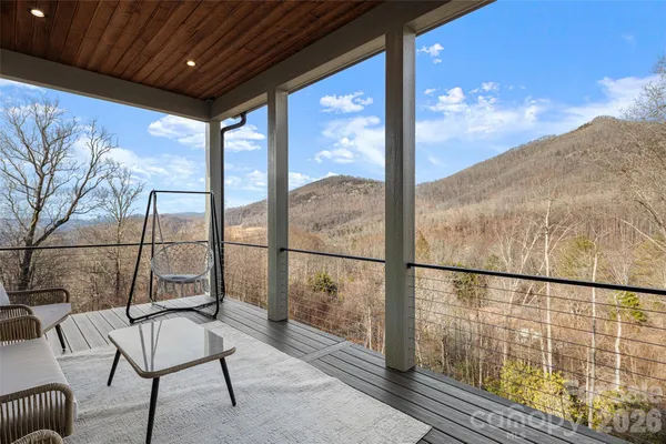a view of a porch with furniture and floor to ceiling window
