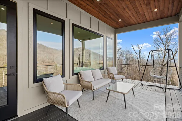 a living room with furniture and a floor to ceiling window