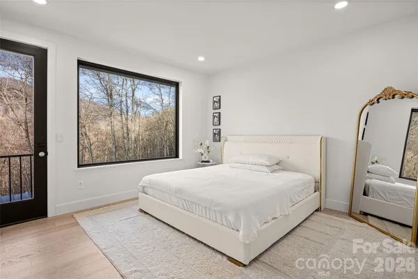 a bedroom with a large bed and a window