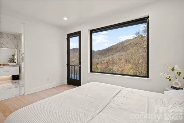 a bedroom with a bed and a painting on the wall