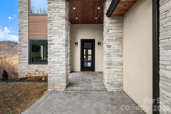 a view of front door of house with stairs