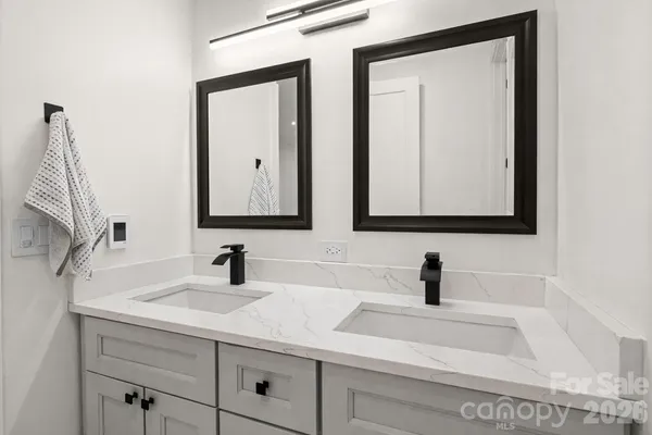 a bathroom with 2 sink and a mirror