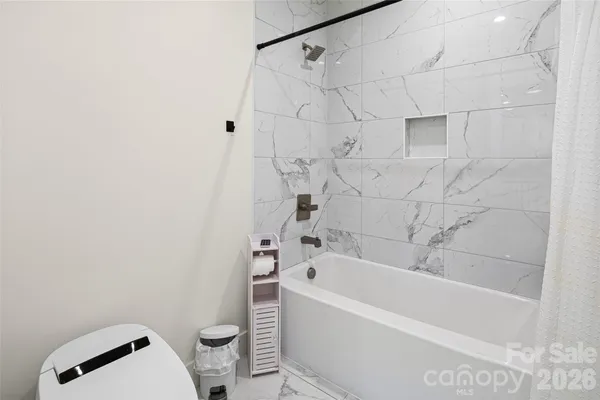 a bathroom with a bathtub and a toilet