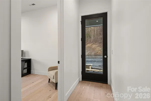 a view of an empty room with a fireplace and a window