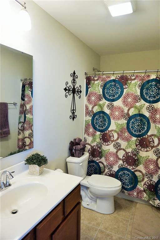 430 Fischer Road, Unit 31 Fort Mill, SC 29715 - Photo 22 of 24 a bathroom with a granite countertop toilet and a sink
