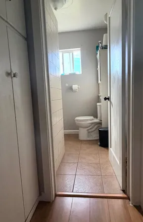 a bathroom with a toilet and a shower