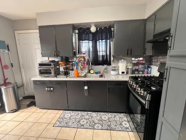 a kitchen with stainless steel appliances granite countertop a refrigerator a stove and a sink