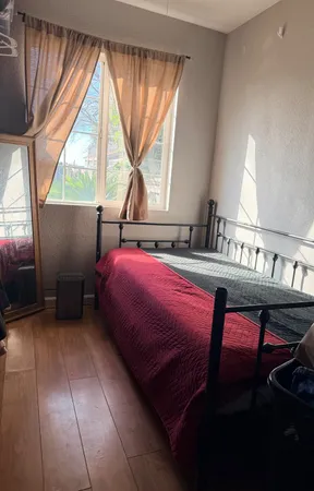a bedroom with a bed and a window