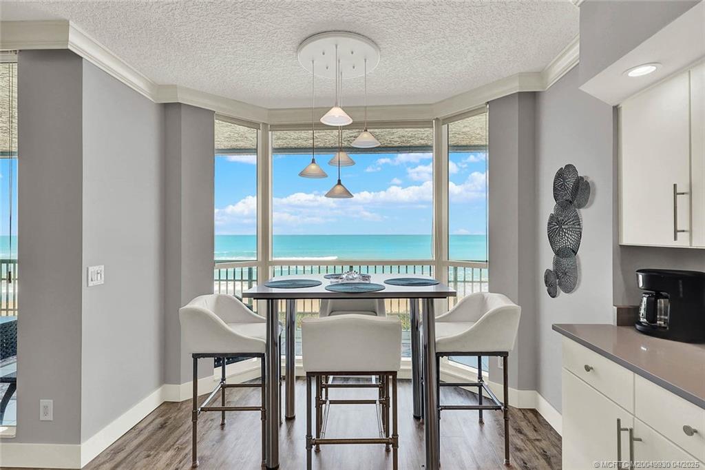 8600 South Ocean Drive, Unit LN3 Jensen Beach, FL 34957 - Photo 22 of 63 a dining room with furniture a chandelier and window