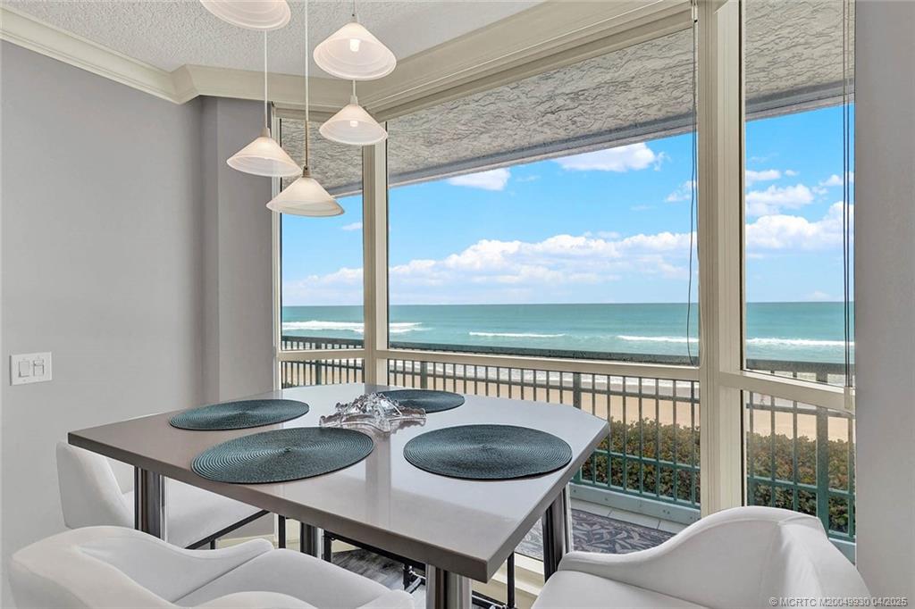 8600 South Ocean Drive, Unit LN3 Jensen Beach, FL 34957 - Photo 24 of 63 a view of a dining room with furniture wooden floor and chandelier