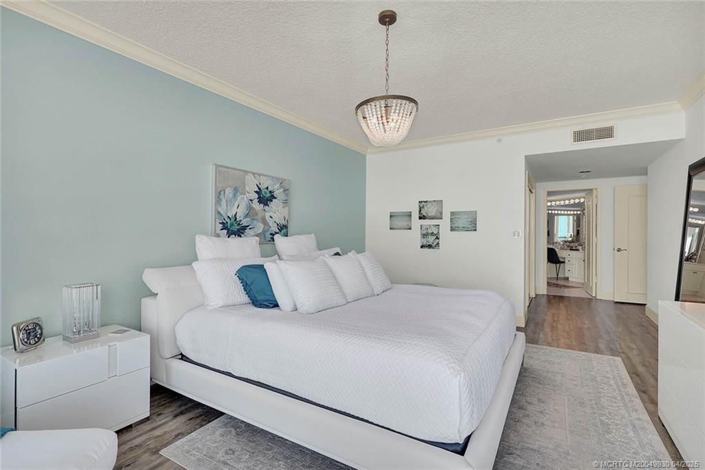 8600 South Ocean Drive, Unit LN3 Jensen Beach, FL 34957 - Photo 28 of 63 a bedroom with a large bed and a chandelier