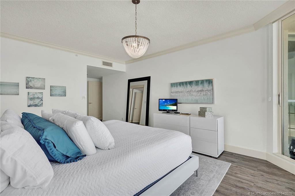 8600 South Ocean Drive, Unit LN3 Jensen Beach, FL 34957 - Photo 29 of 63 a bedroom with a bed and ceiling fan