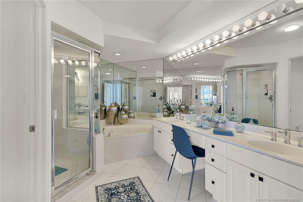 8600 South Ocean Drive, Unit LN3 Jensen Beach, FL 34957 - Photo 31 of 63 a bathroom with a double vanity sink mirror and shower