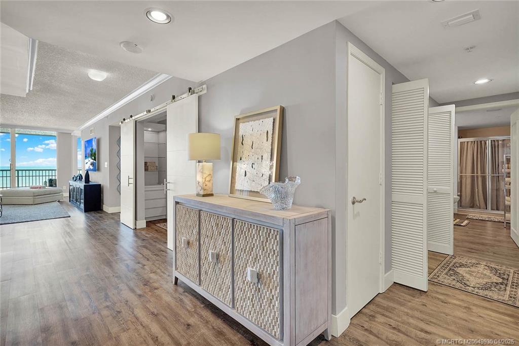 8600 South Ocean Drive, Unit LN3 Jensen Beach, FL 34957 - Photo 33 of 63 a view of a hallway view with wooden floor and staircase