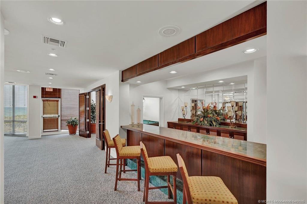 8600 South Ocean Drive, Unit LN3 Jensen Beach, FL 34957 - Photo 61 of 63 a room with lots of wooden furniture and large windows