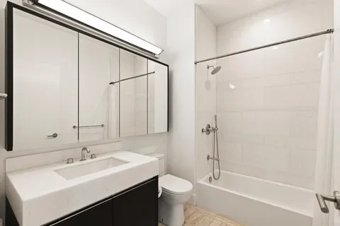 a bathroom with a sink toilet and shower