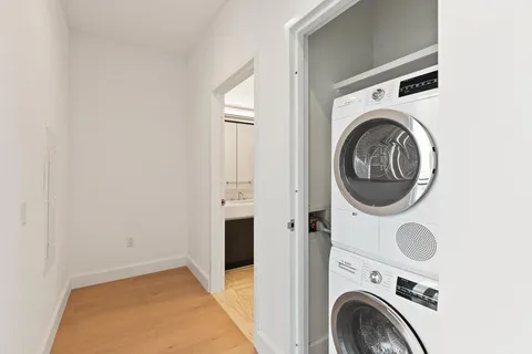 a view of a storage & utility room with dryer and washer