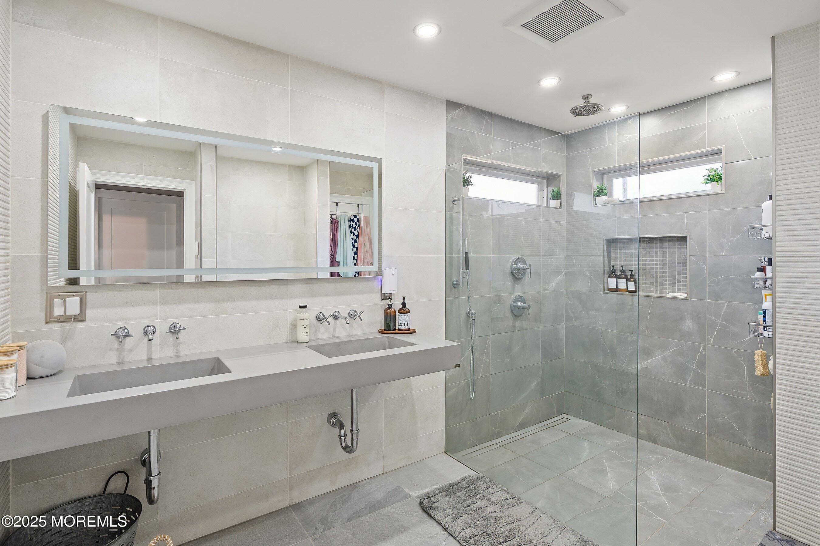 409 Aldrich Road Howell, NJ 07731 - Photo 15 of 27 a bathroom with a double vanity sink mirror and shower