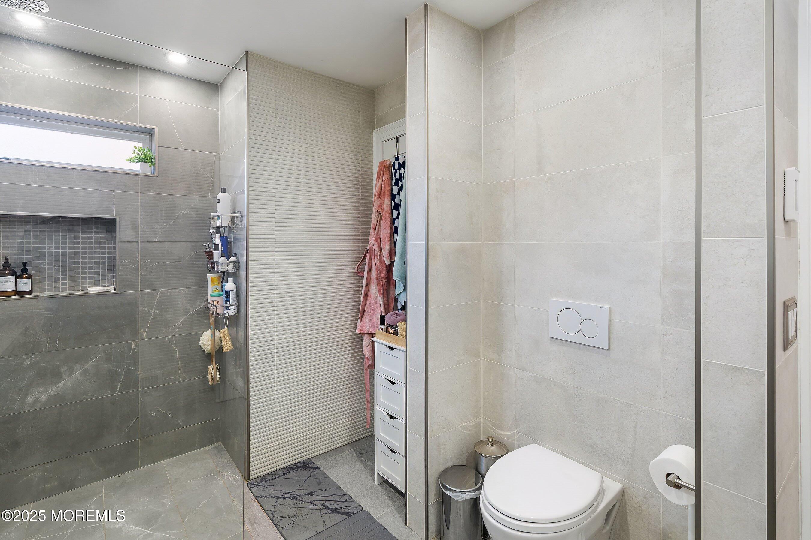 409 Aldrich Road Howell, NJ 07731 - Photo 16 of 27 a bathroom with a toilet a sink and shower