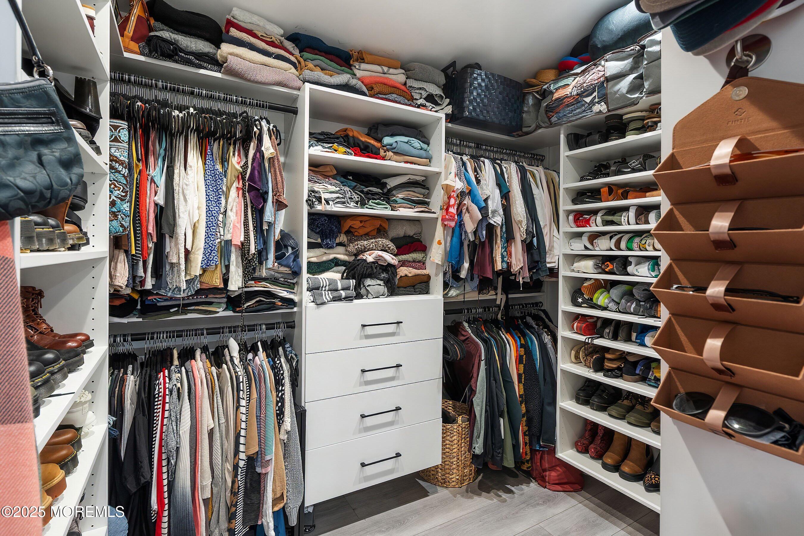 409 Aldrich Road Howell, NJ 07731 - Photo 17 of 27 a view of walk in closet with clothes and shoes