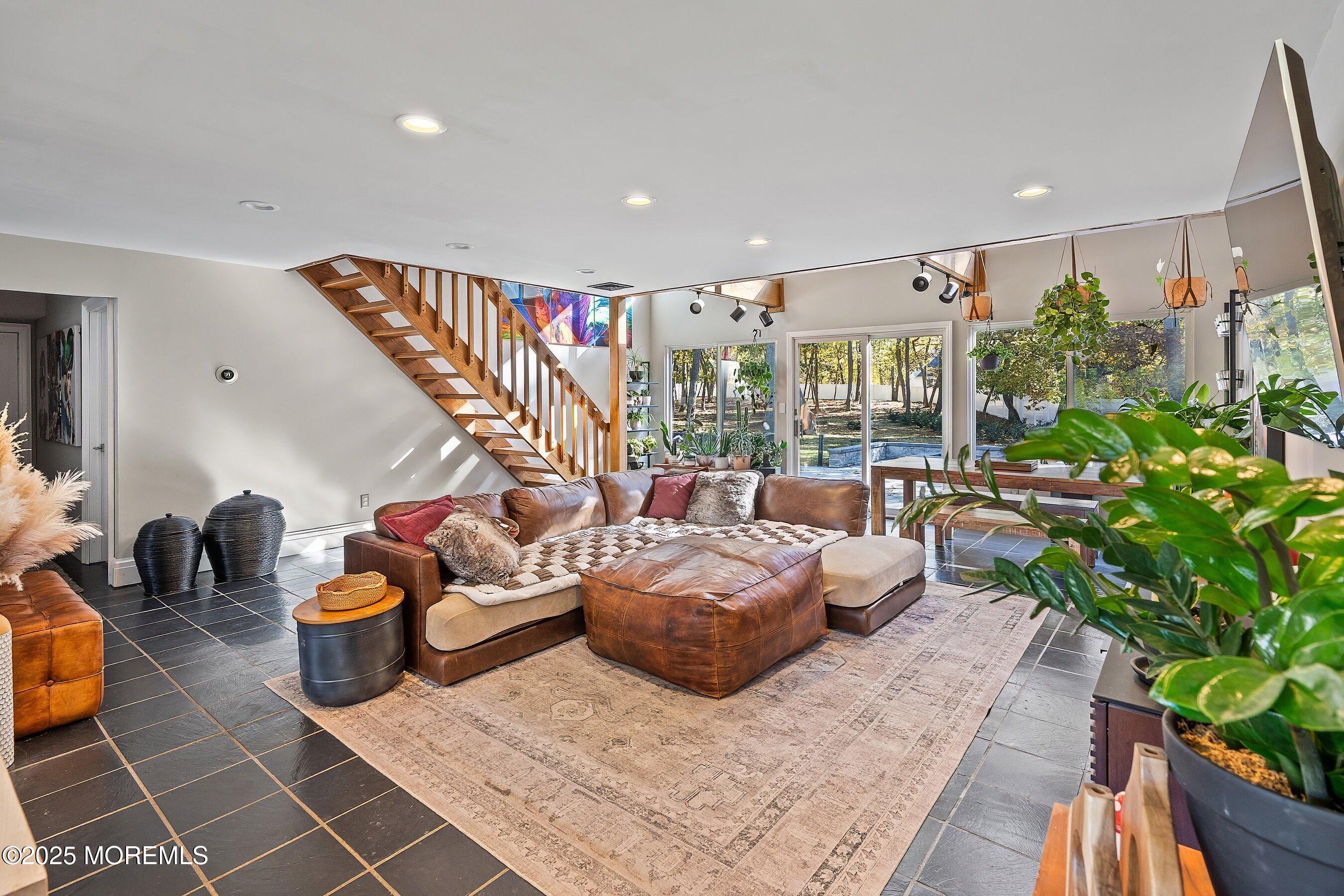 409 Aldrich Road Howell, NJ 07731 - Photo 7 of 27 a living room with patio furniture and a potted plant