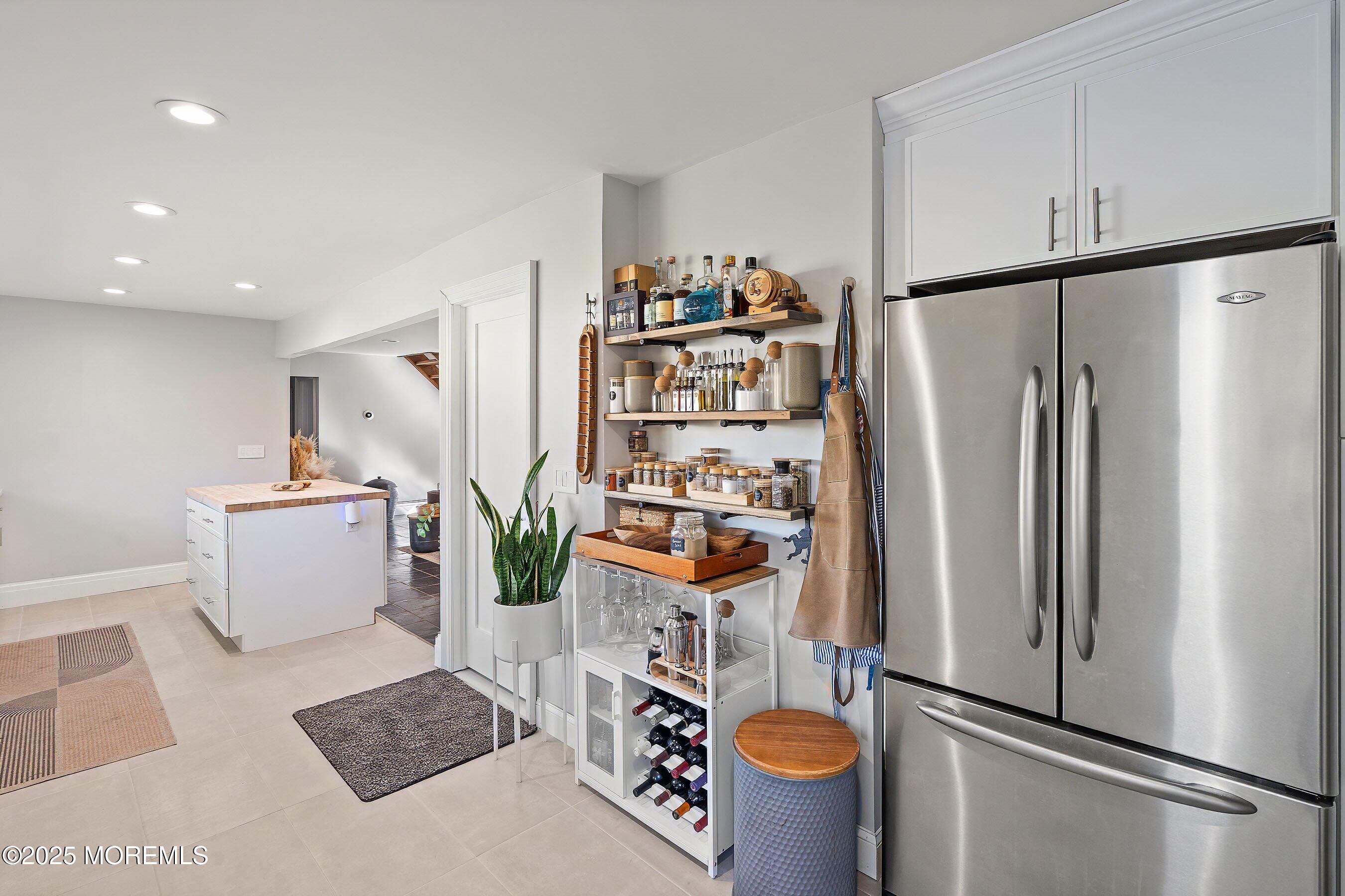 409 Aldrich Road Howell, NJ 07731 - Photo 10 of 27 a kitchen with stainless steel appliances a refrigerator a stove a sink and a dining table