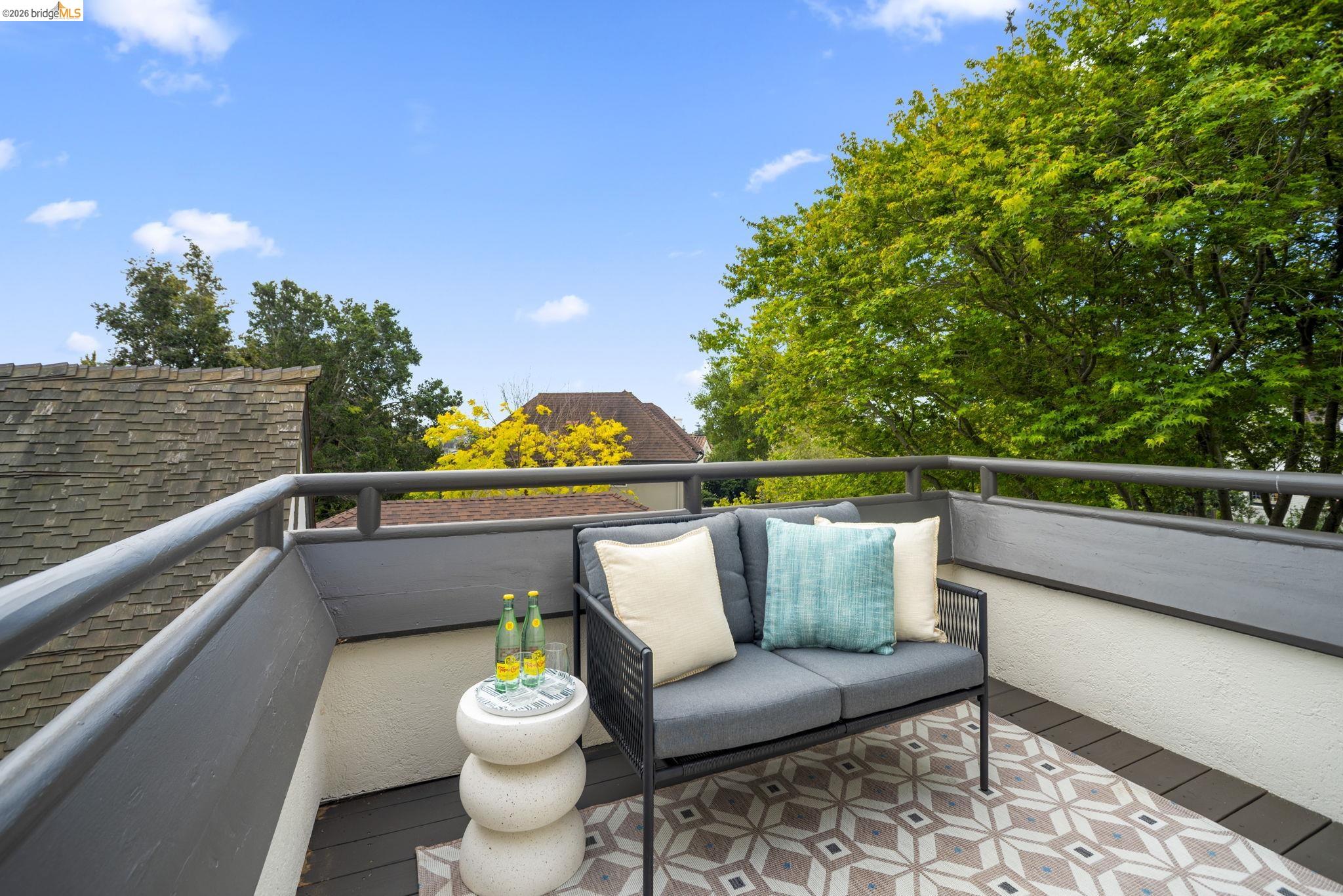 1087 Hubert Road Oakland, CA 94610 - Photo 29 of 67 Rooftop deck featuring a patterned outdoor rug, dark wood-finish flooring, and a sturdy perimeter railing