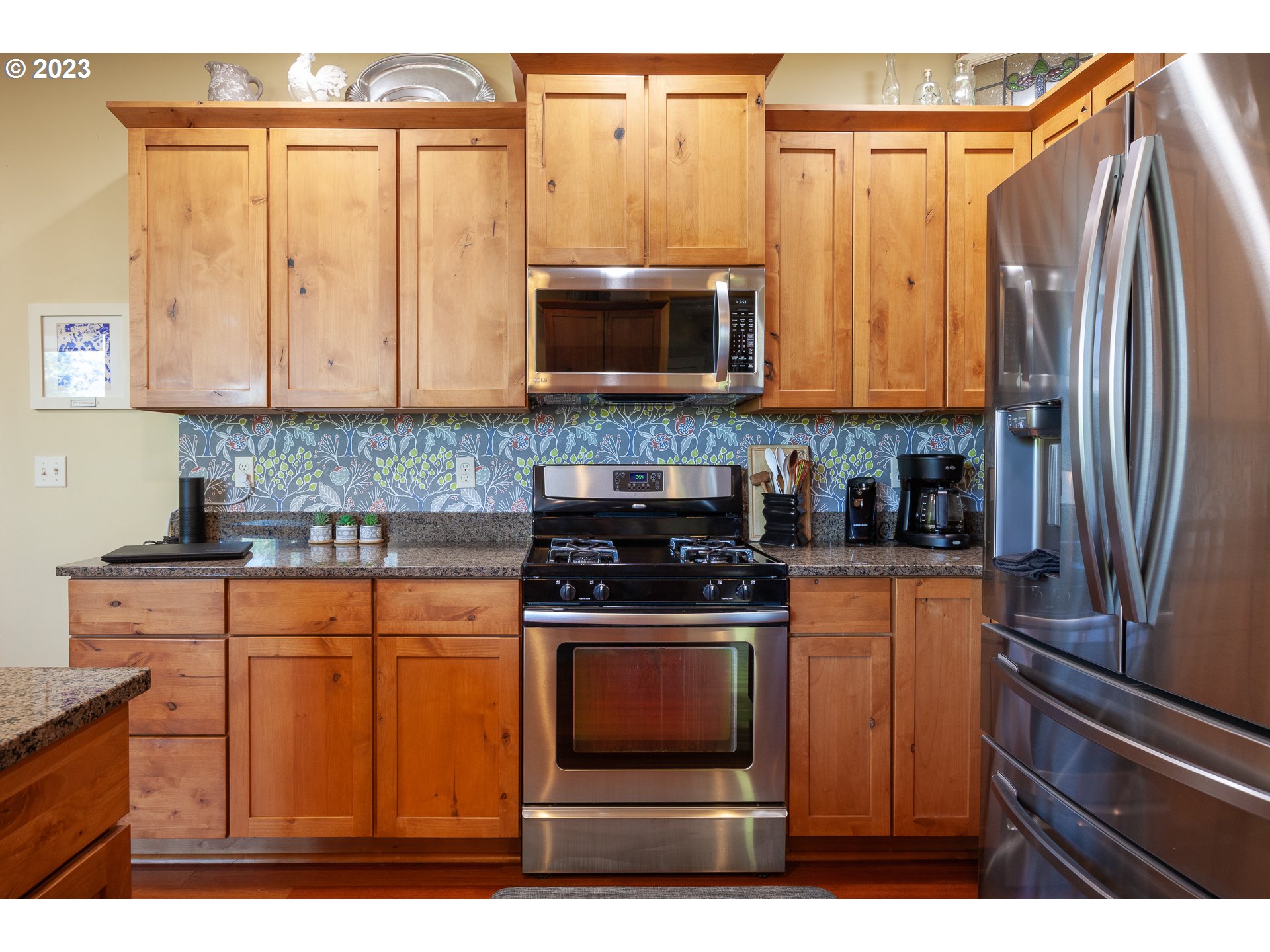 1615 4th Street Hood River, OR 97031 - Photo 11 of 33 a kitchen with stainless steel appliances granite countertop a stove a sink and a refrigerator