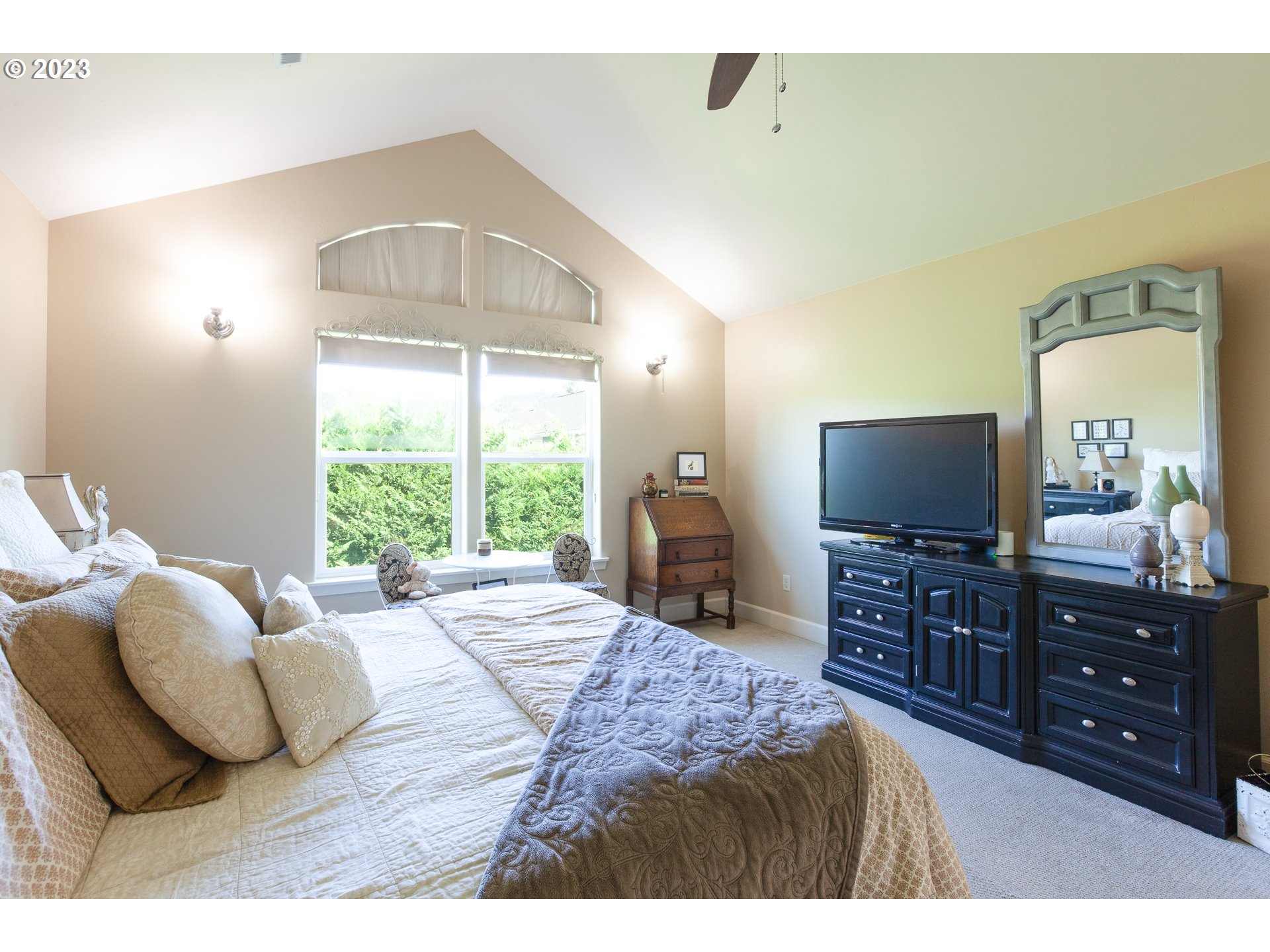 1615 4th Street Hood River, OR 97031 - Photo 17 of 33 a bedroom with a bed and a flat tv screen on dresser
