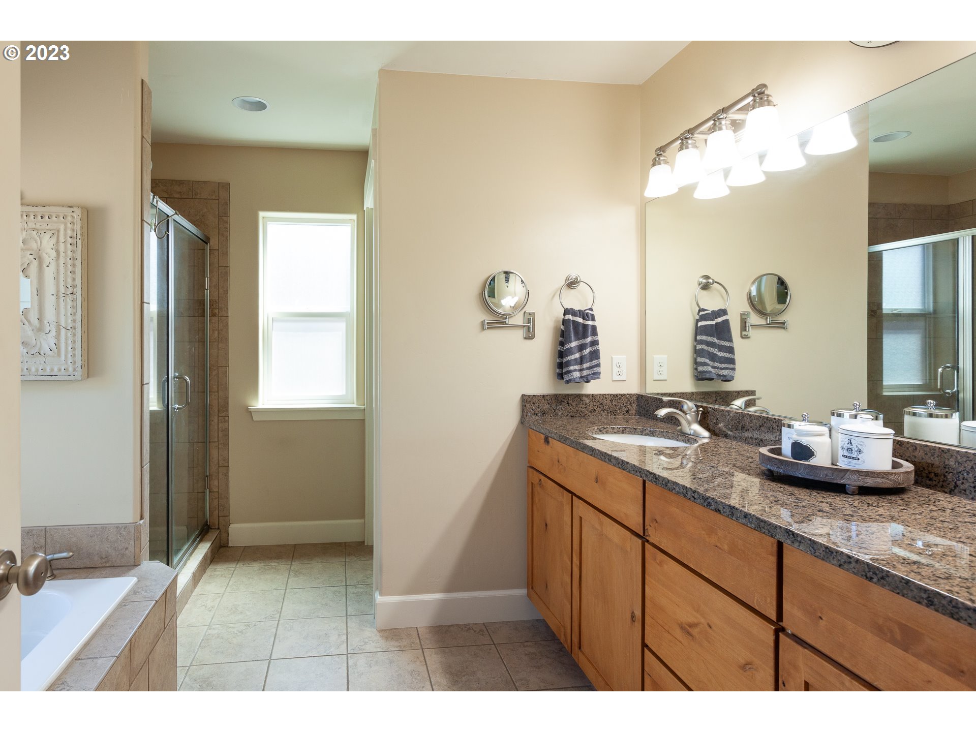 1615 4th Street Hood River, OR 97031 - Photo 20 of 33 a bathroom with a granite countertop sink a large mirror and shower