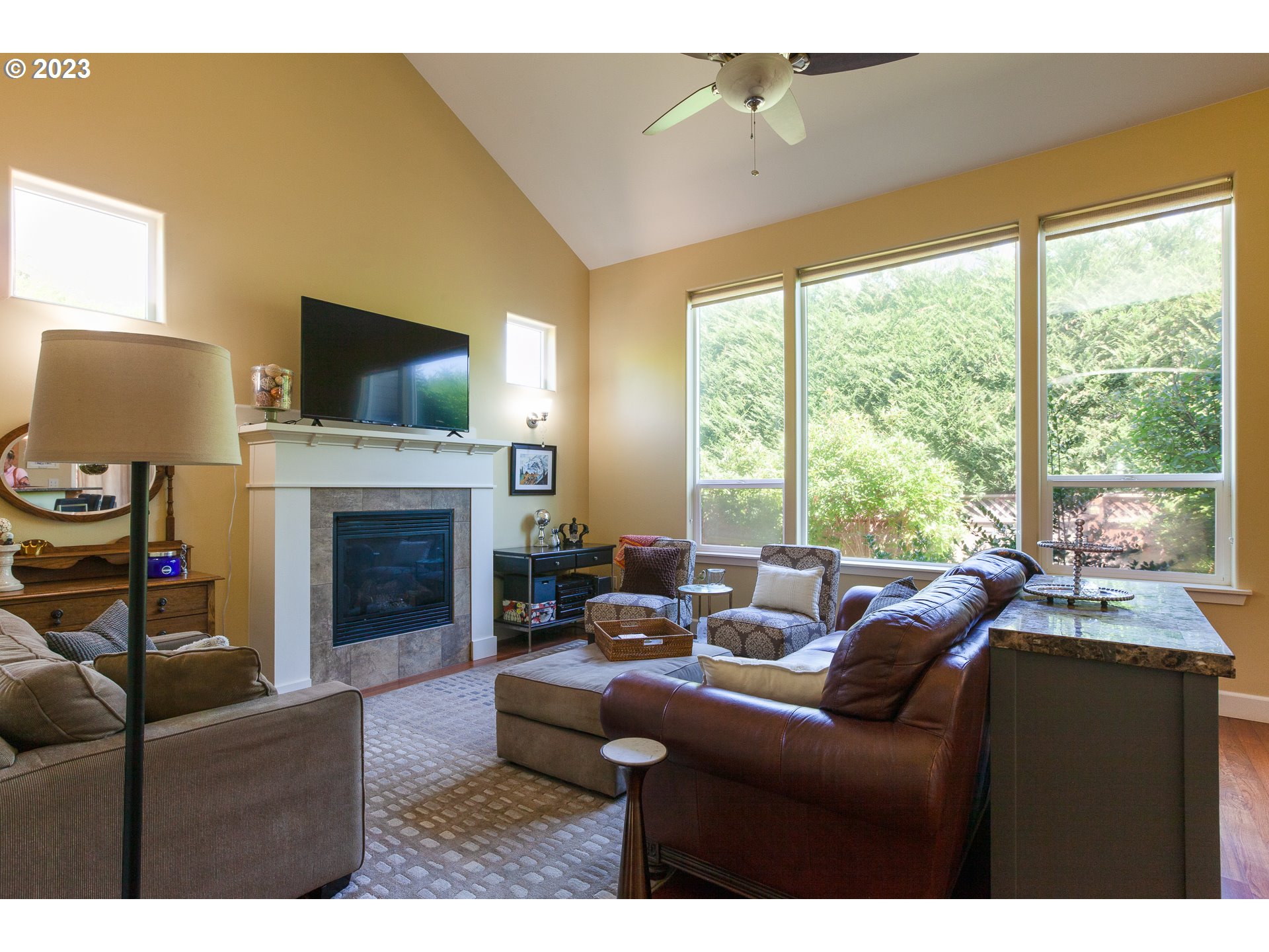1615 4th Street Hood River, OR 97031 - Photo 5 of 33 a living room with furniture a flat screen tv and a fireplace