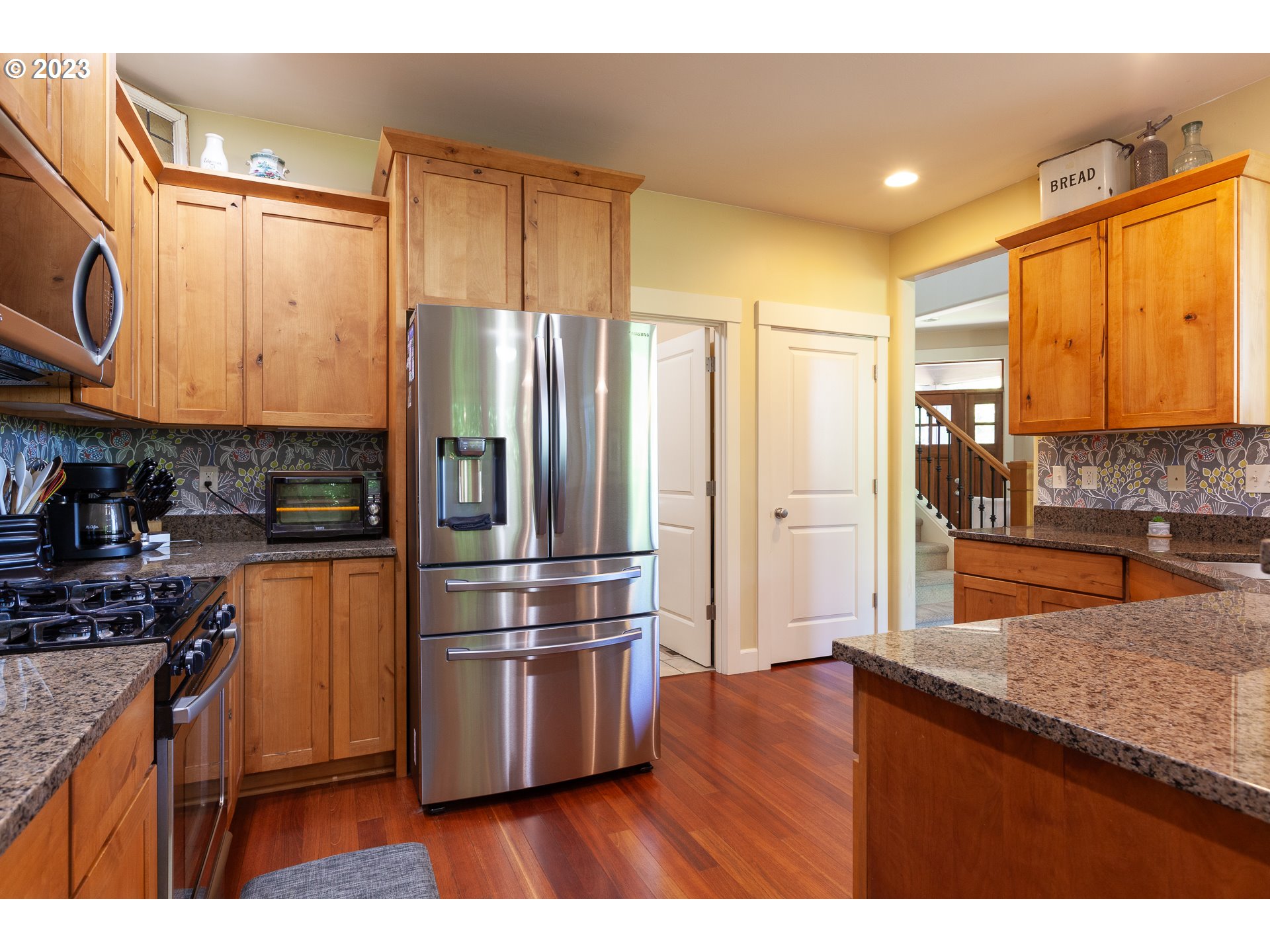 1615 4th Street Hood River, OR 97031 - Photo 10 of 33 a kitchen with stainless steel appliances granite countertop a refrigerator and a stove