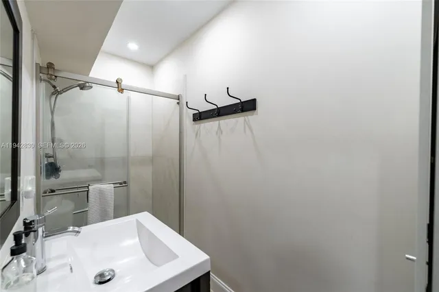 a bathroom with a sink and shower