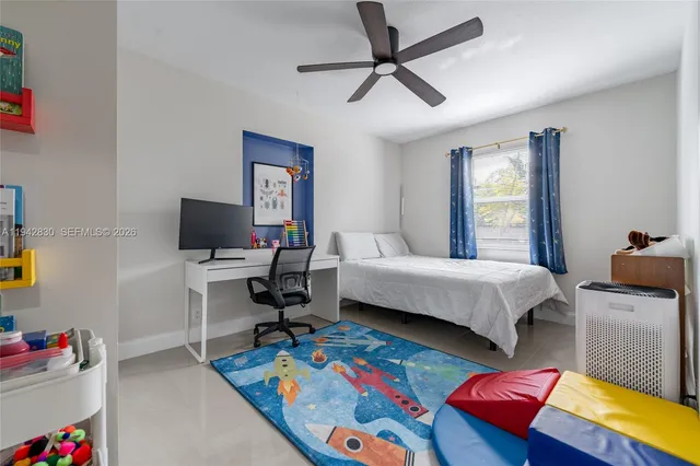 a bedroom with a bed a couch and a window