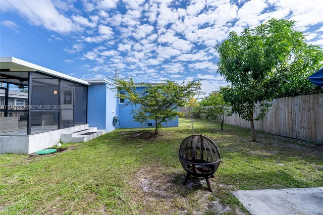 a view of a backyard with a small barn and entertaining space